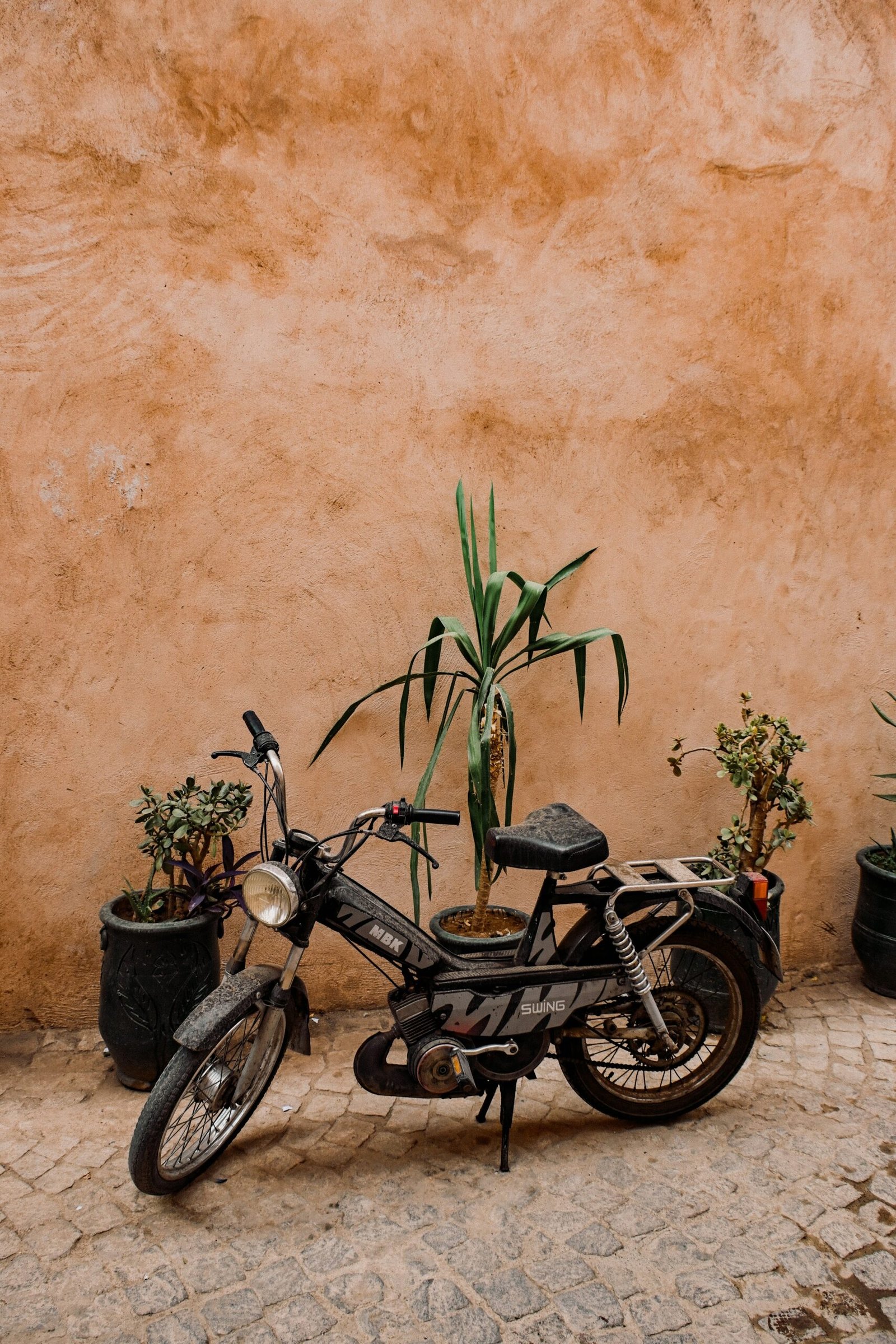 a motorcycle parked next to a wall